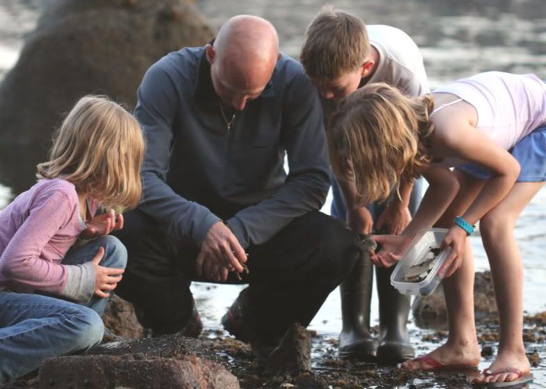 kids and Dad explore a rocky coast looking for beach glass and antique fishing lures
